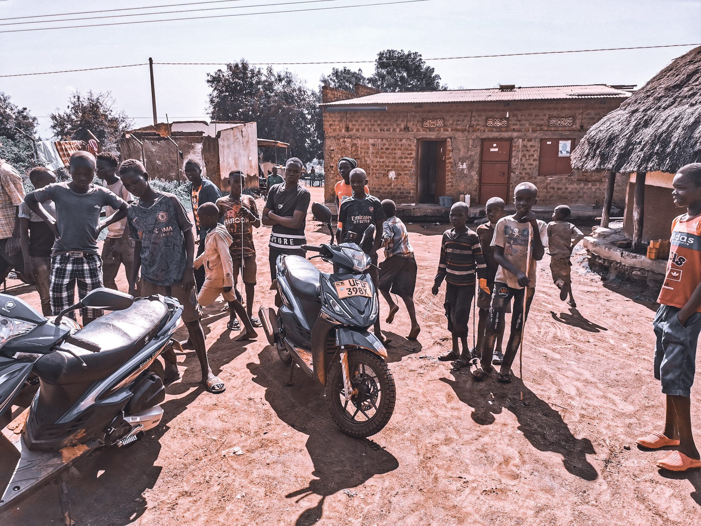 Vi är en syn i varje by i Uganda - vilka är de där två vita männen på de där konstiga mopederna?
